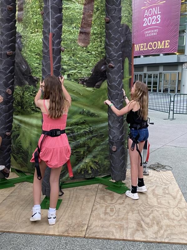 Trying their skills at the palm tree climbing competition during the BPA SoCal Bash are Natalie Longo, left, and Hannah Wells. At the end of the climb, Hannah beat Natalie to the top, although great debate continues.